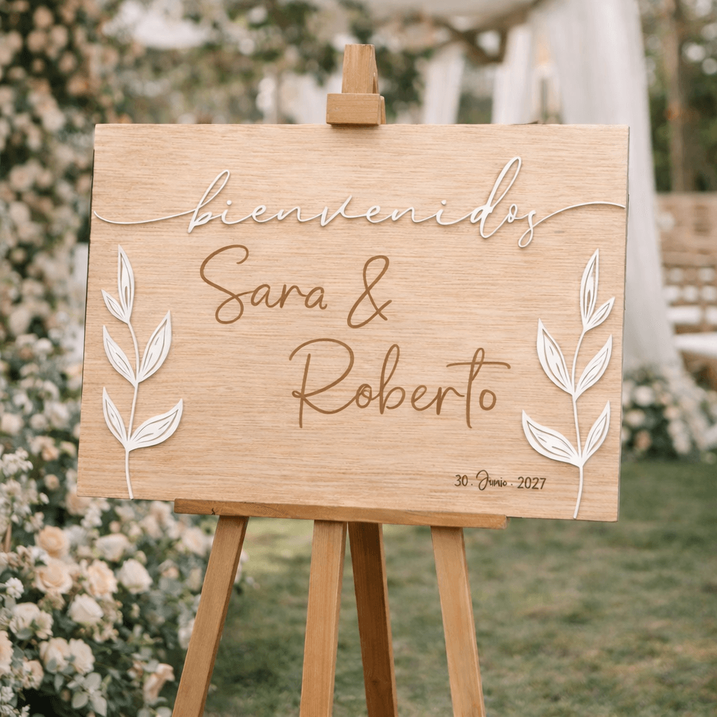 Detalle de hojas naturales grabadas a láser en cartel de boda de madera diseño botánico
