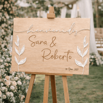 Detalle de hojas naturales grabadas a láser en cartel de boda de madera diseño botánico

