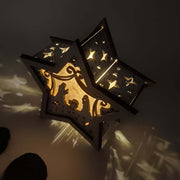 Lámpara rústica estilo nórdico de madera con estrella y pesebre iluminado para Navidad.
