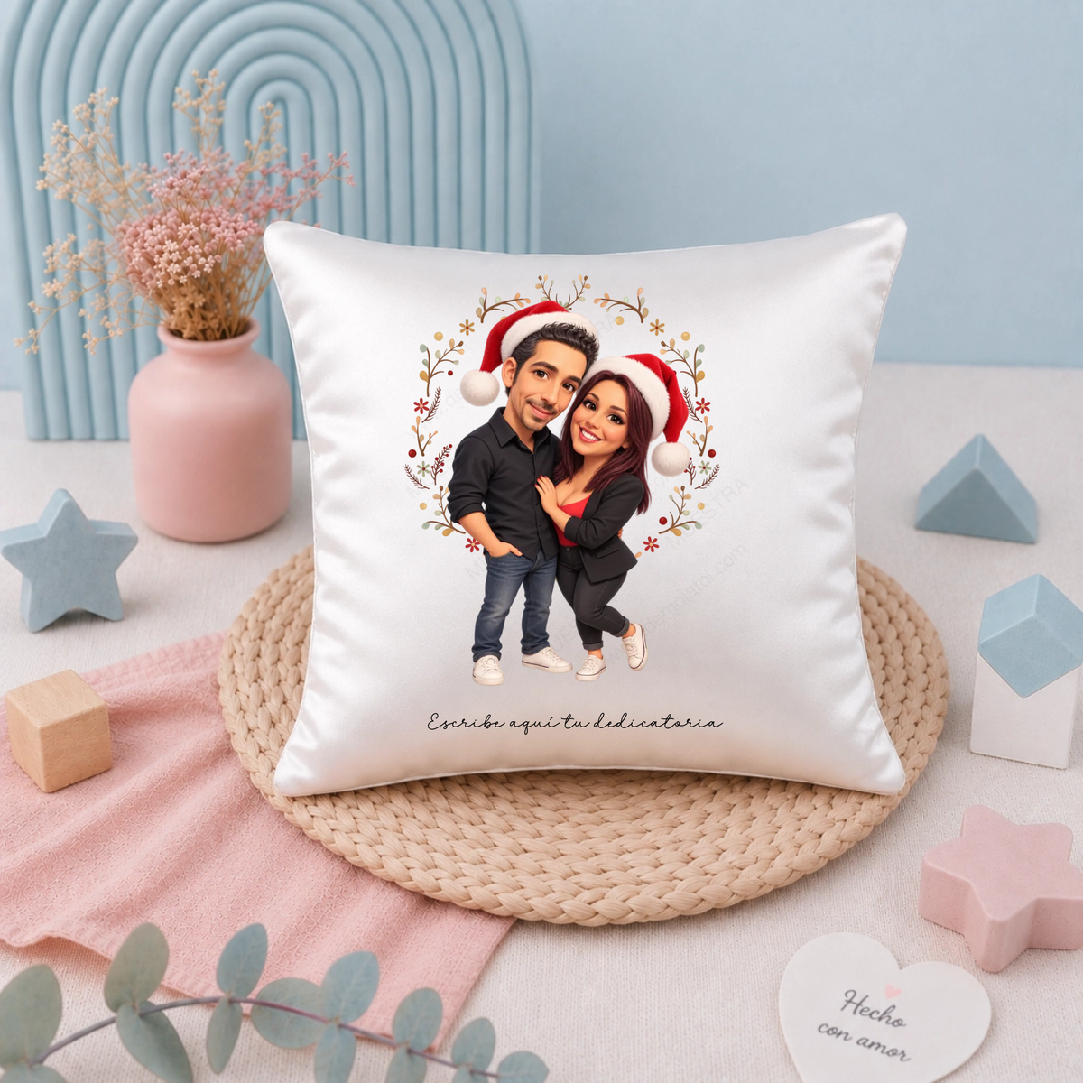 Cojín personalizado con caricatura navideña de pareja con gorros de Papá Noel y dedicatoria